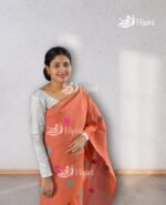 Model wearing orange coloure handmade(handloom) nuni cotton mekhela sador