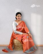 Model wearing orange coloure handmade(handloom) nuni cotton mekhela sador